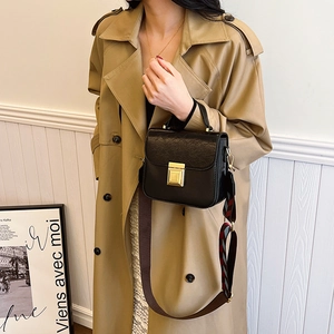 Black crocodile pattern crossbody square bag with colorful wide strap on khaki trench coat