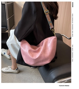Detail of pink half-moon crossbody bag with geometric pattern wide shoulder strap