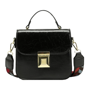 Chic black textured leather square bag with wide jacquard strap and gold buckle