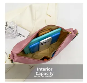 Spacious interior of pink crossbody bag showing phone, wallet, and tablet storage