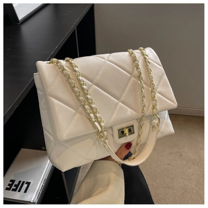 Close-up of quilted white faux leather bag with gold twist lock and chain strap
