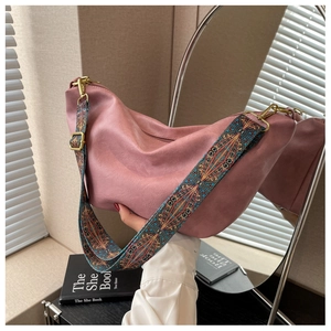 Detail of dusty pink hobo bag featuring geometric embroidery wide shoulder strap