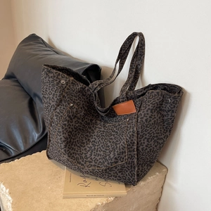 Large leopard print canvas tote bag with front pocket and decorative leather patch