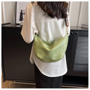 Crescent crossbody bag in grass green with detailed vintage ethnic patterned wide strap