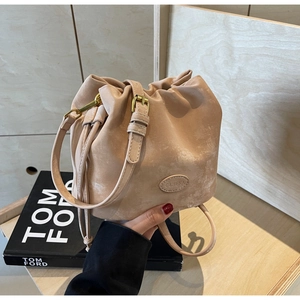 Close-up of matte suede bucket bag with C&HEKA logo and drawstring closure