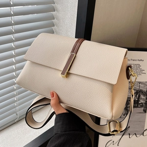 Beige faux leather crossbody bag with brown accent strap and woven canvas shoulder strap