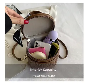 Internal capacity of quilted bucket bag showing phone, umbrella and daily essentials