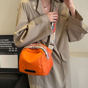 Orange canvas shell crossbody bag with ethnic floral embroidered strap for women
