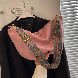 Pink matte leather crescent bag with colorful ethnic woven shoulder strap for women