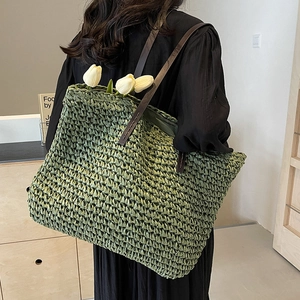 Large grass green straw tote bag with brown leather handles for beach and daily commute
