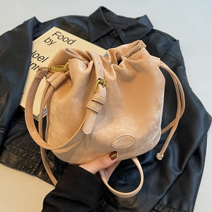 Chic beige matte bucket bag with drawstring closure and retro gold hardware for women