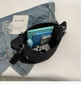 Interior view of large black tote bag showing spacious storage for tablets and a water bottle