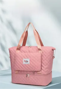 Detail of pink quilted waterproof nylon travel bag with independent bottom zipper compartment