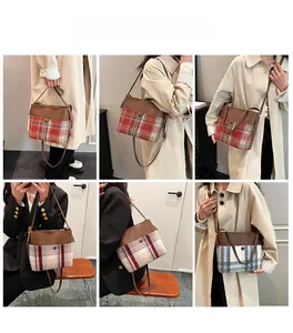 Detail of tweed and leather patchwork bucket bag showing multiple carrying styles