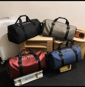 Close-up of durable oxford fabric travel duffel bags in black, grey, red and blue