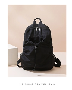 Detail view of large nylon travel backpack with drawstring pocket and smooth zippers