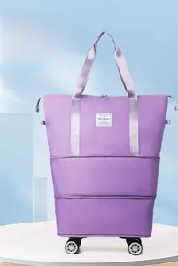 Detail of purple waterproof travel bag with 4 swivel wheels and expandable base