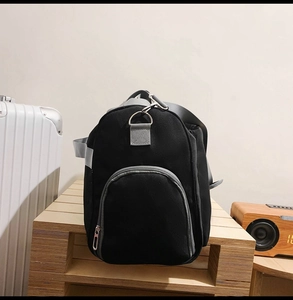 Détail du sac de voyage noir en tissu Oxford avec compartiment zippé latéral et anneau en D