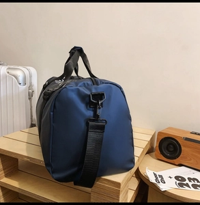Detail of waterproof Oxford tote bag showing side D-ring and adjustable shoulder strap