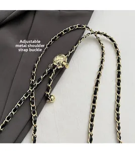 Detail of adjustable gold metal ball buckle with black leather chain strap for handbags