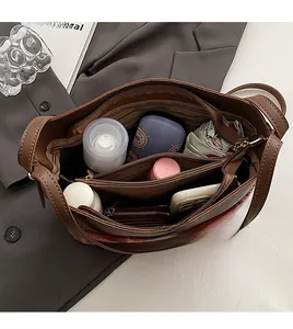 Top view of spacious brown tote bag interior with three compartments and zip pocket