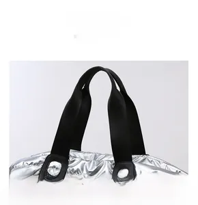 Gros plan sur les poignées rembourrées noires du sac fourre-tout argenté brillant Oxford