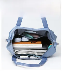 Internal view of large capacity blue oxford tote showing organized travel essentials