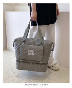 Macro detail of grey quilted Oxford fabric travel tote with independent shoe compartment