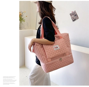 Pink quilted travel bag featuring a separate bottom wet-dry compartment for fitness
