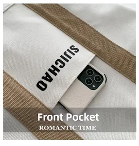 Detail view of the canvas tote front pocket with phone storage and SIJICHAO print