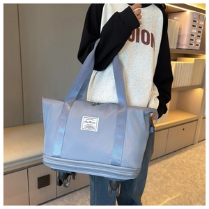 Detail of the gray-blue travel bag featuring silent wheels and reinforced base support