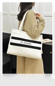 Détail du grand sac cabas en toile avec rayures noires et texte SI.JICHAO pour femme
