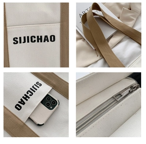 Detailed close-up of canvas tote bag with khaki handles and premium metallic zipper