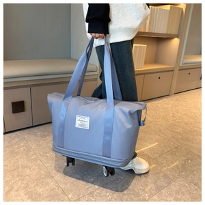 Detail view of large capacity waterproof oxford travel bag with integrated swivel wheels