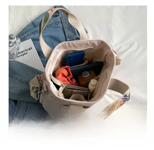 Internal view of a large nylon tote bag showing multiple pockets and storage capacity