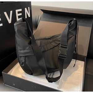 Close-up of black nylon hobo bag with adjustable strap and buckle in premium gift box