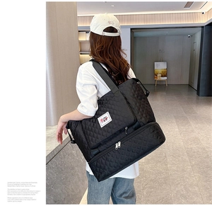 Detail of quilted oxford travel bag showing the double-layer structure and bottom shoe compartment