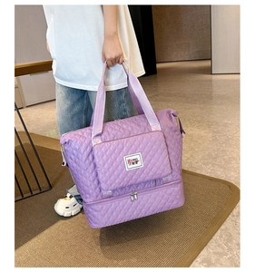 Close-up of purple quilted nylon travel tote featuring a front pocket and shoe compartment