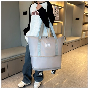 Close-up of light grey waterproof nylon travel bag with wheels and fashion logo