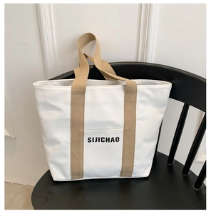 Macro shot of durable canvas tote bag with contrast strap and SIJICHAO logo pocket