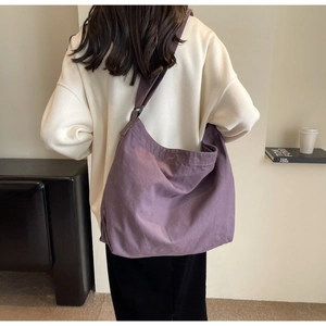 Detail of purple canvas hobo bag with adjustable wide strap for casual wear