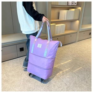Detail of purple Oxford travel bag with bottom wheels and water-resistant fabric