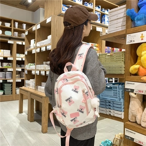 White backpack with pink cartoon bear prints and double zipper storage compartments