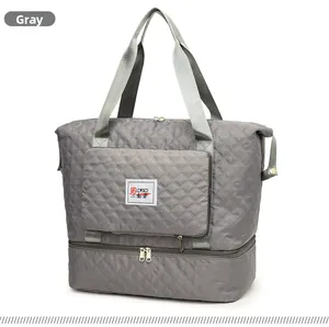 Detail of gray quilted oxford bag featuring a front pocket and separate bottom compartment