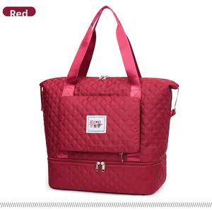 Detail view of the red quilted nylon travel bag featuring the bottom shoe compartment