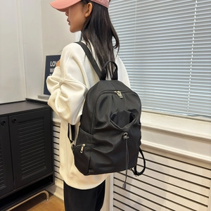 Black nylon waterproof backpack with drawstring pocket for school and travel