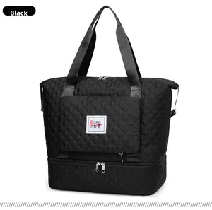 Detail of black quilted Oxford fabric travel bag with reinforced handles and dual structure