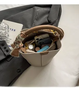 Detailed interior of the beige lychee pattern bucket bag showing large storage capacity