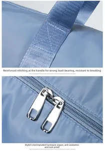 Detail of reinforced cross-stitching on fabric straps and dual metal zippers on travel bag
