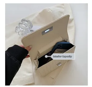 Detail view of cream quilted chain bag interior capacity for phone and wallet essentials